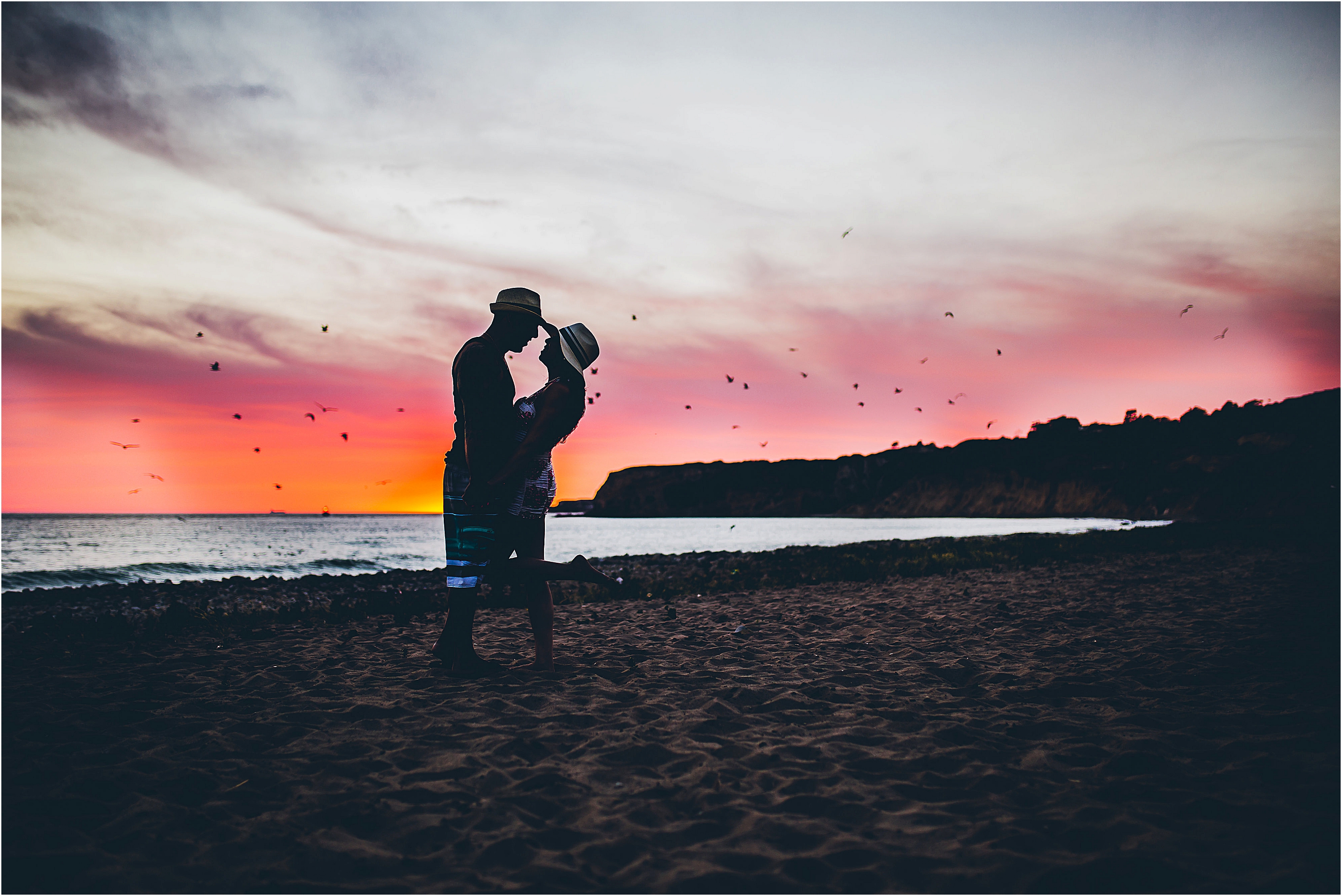 Beautiful sunset colors during engagement photo session at private beach in southern california.