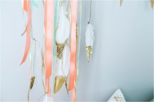 Ribbon and feather decor for nursery