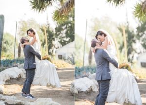 groom lifts bride for kiss