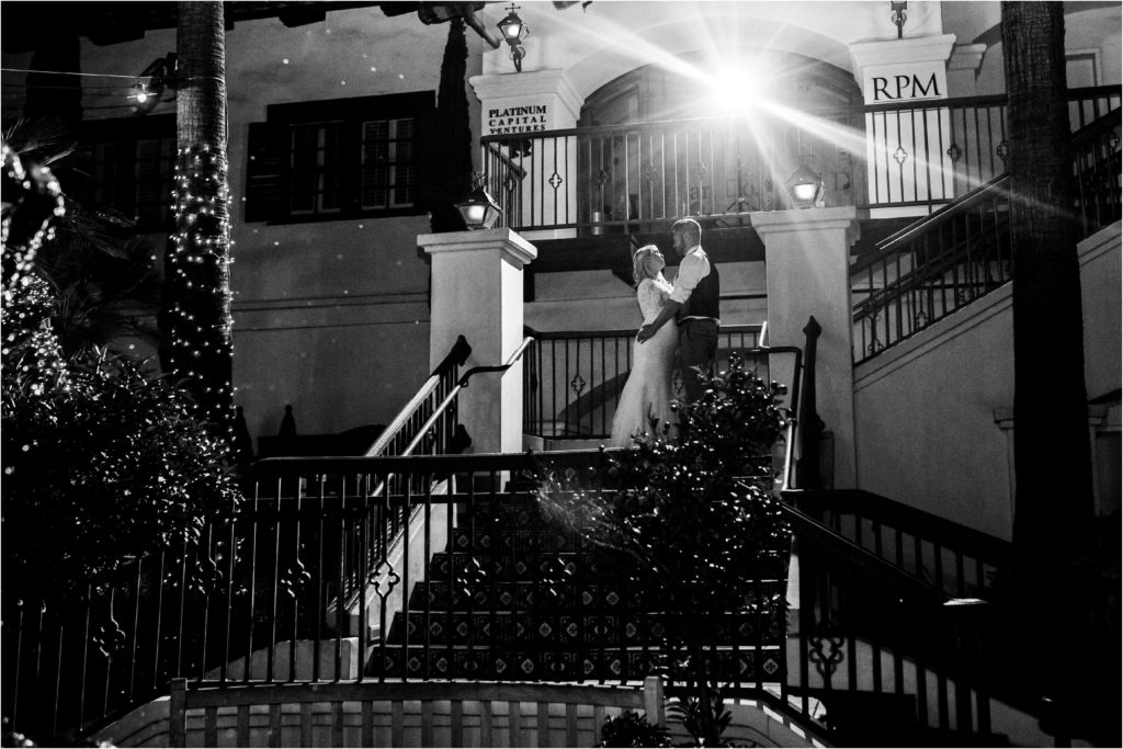 black and white bride and groom posing on stairs
