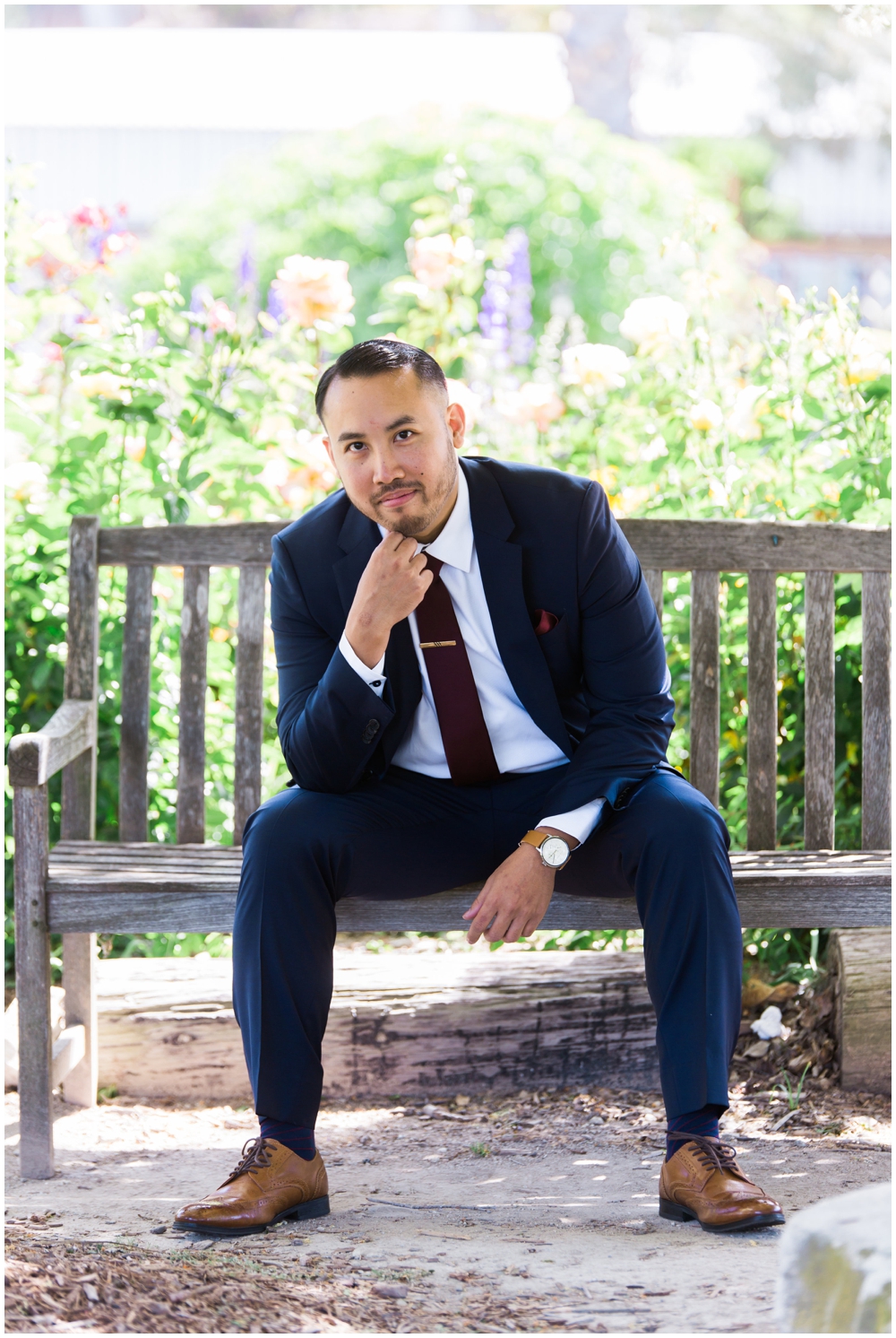 grooms portrait sitting on bench