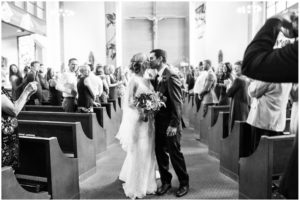 kissing in the middle of the ceremony aisle