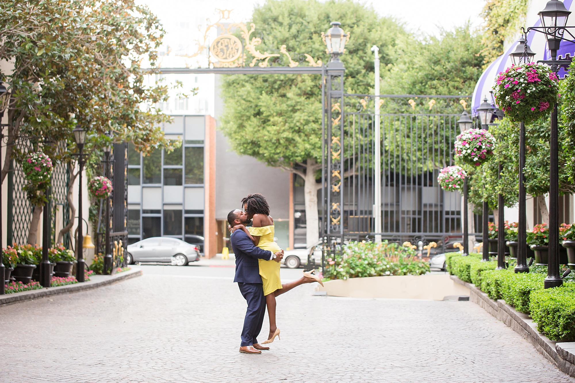 beverly hills engagement photography of man and woman dancing in driveway at hotel