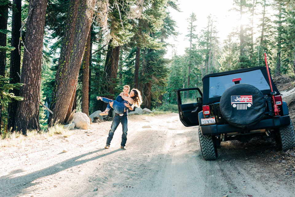 Man twirling girl on a jeep trail