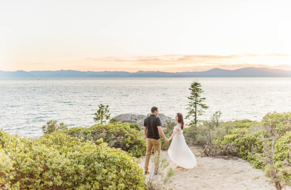 lake tahoe engagement photos of couple dancing on the shore