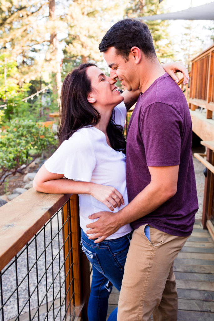 lake tahoe brewery engagement photo of couple posing nose to noce
