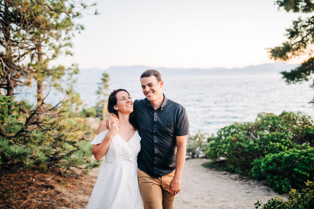 lake tahoe engagement photos with man wrapping arm around girl