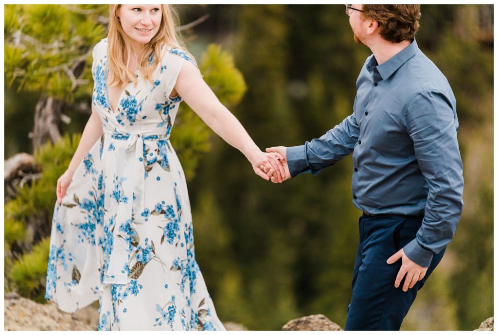 woman looking at man while they hold hands