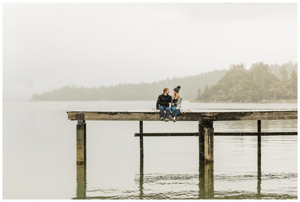 couple sitting on lake tahoe pier