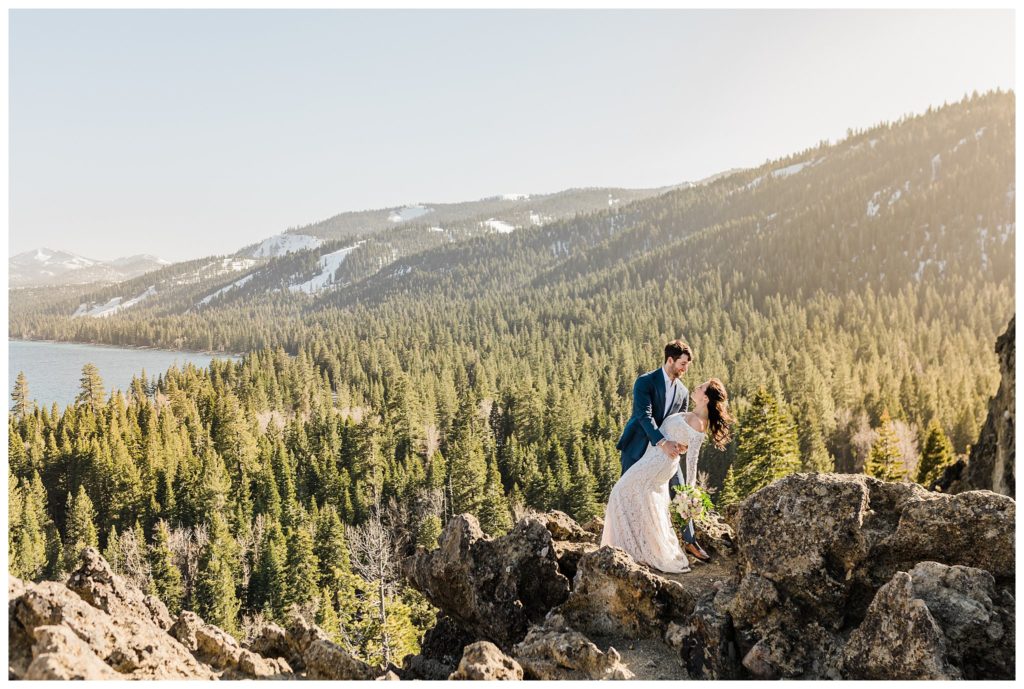 groom dipping bride on top of eagle rock, lake tahoe