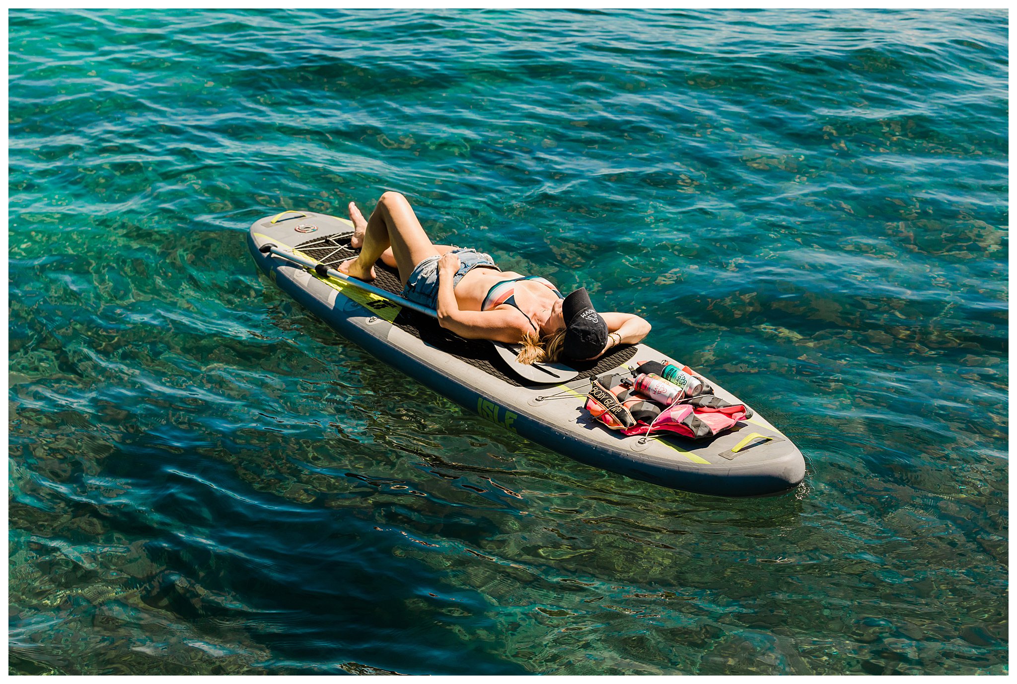 woman laying out on paddle board