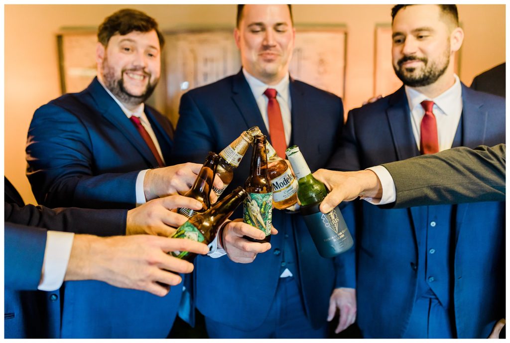 groomsmen toasting their beers