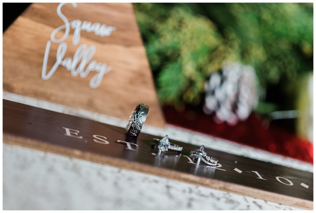 close up photos of rings on a personalized ski with the couples names