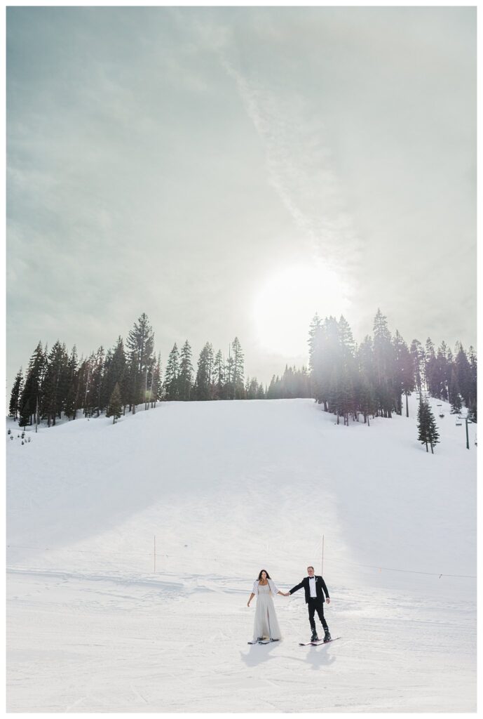 wedding couple skiing and holding hands at homewood resorts