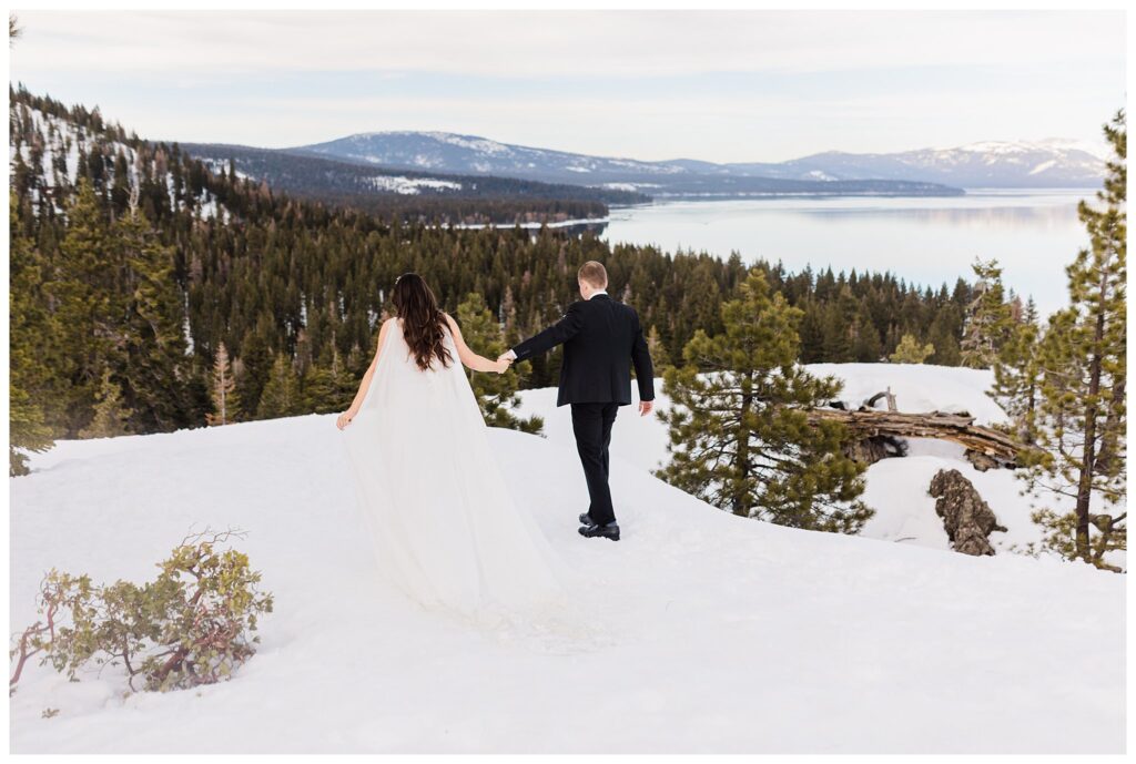 wedding couple walking in the snow holding hands in lake tahoe