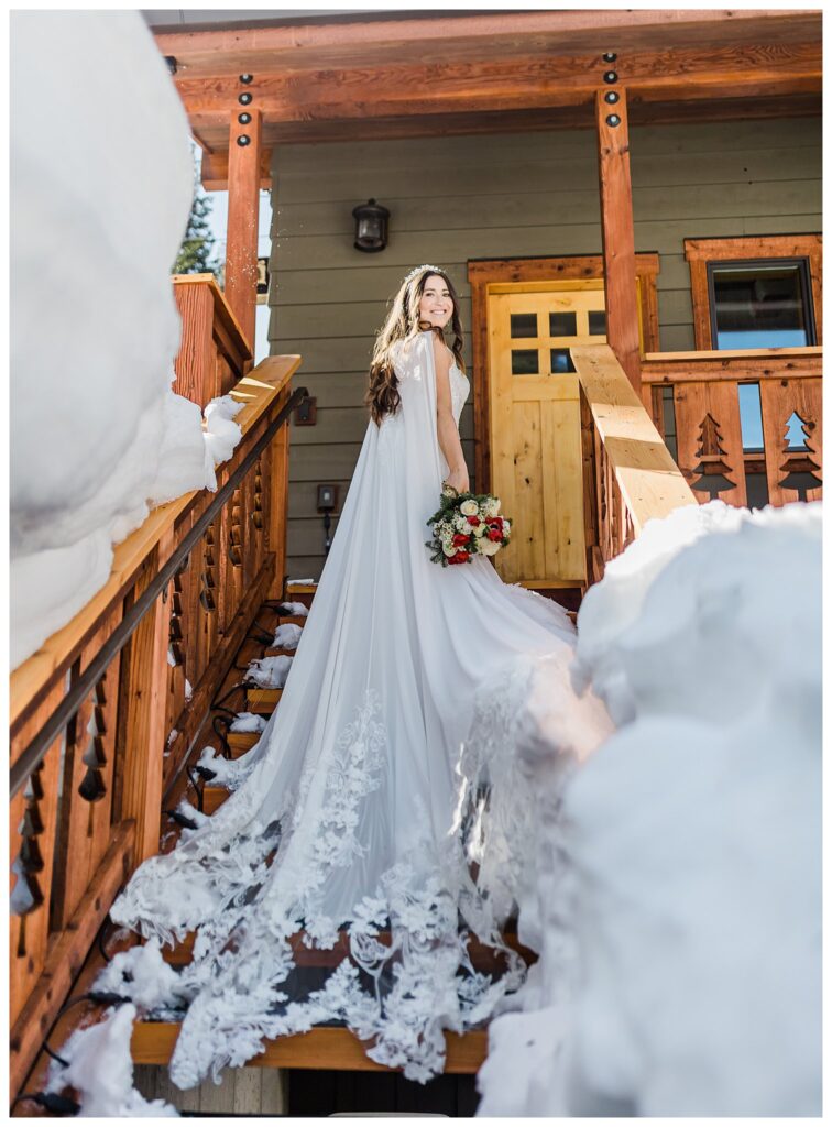 bride showing her cape on her enzoani wedding dress