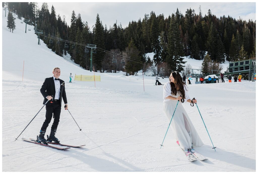 bride and groom skiing in wedding clothes at homewood resort in lake tahoe