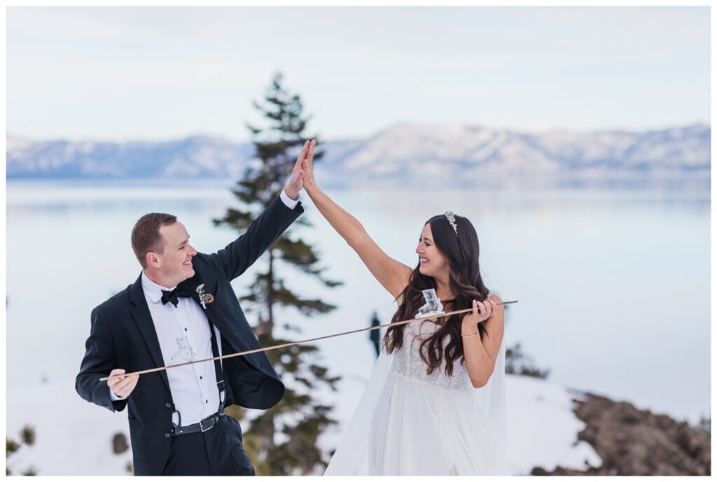 wedding couple high fiving while holding a shot ski in lake tahoe