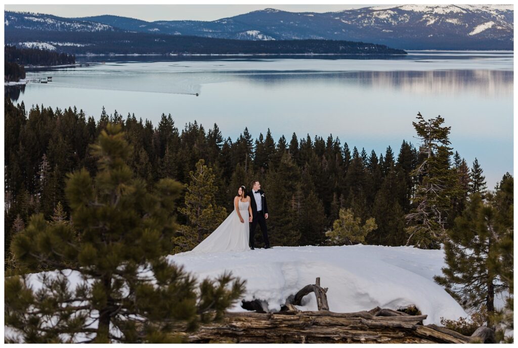 wedding couple posing on eagle rock overloooking lake tahoe