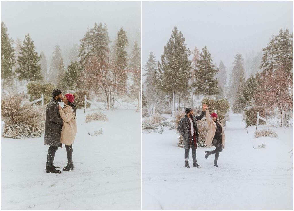 Couple in winter clothing enjoying a snowy landscape, standing amidst trees and snow-covered ground.